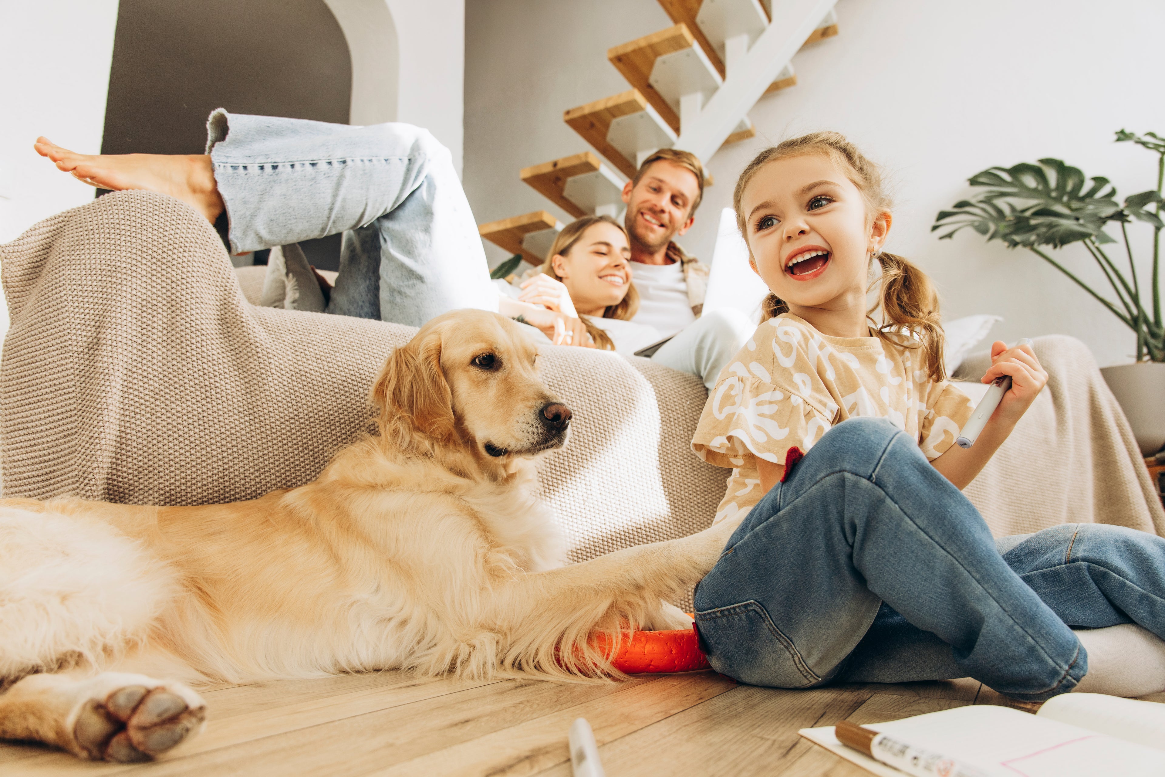 Nice happy family on a couch with a pet
